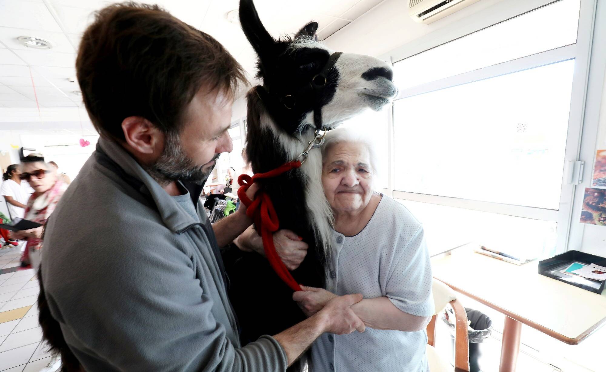 Lama Joel visits residents of the long-term care unit in San Rafael