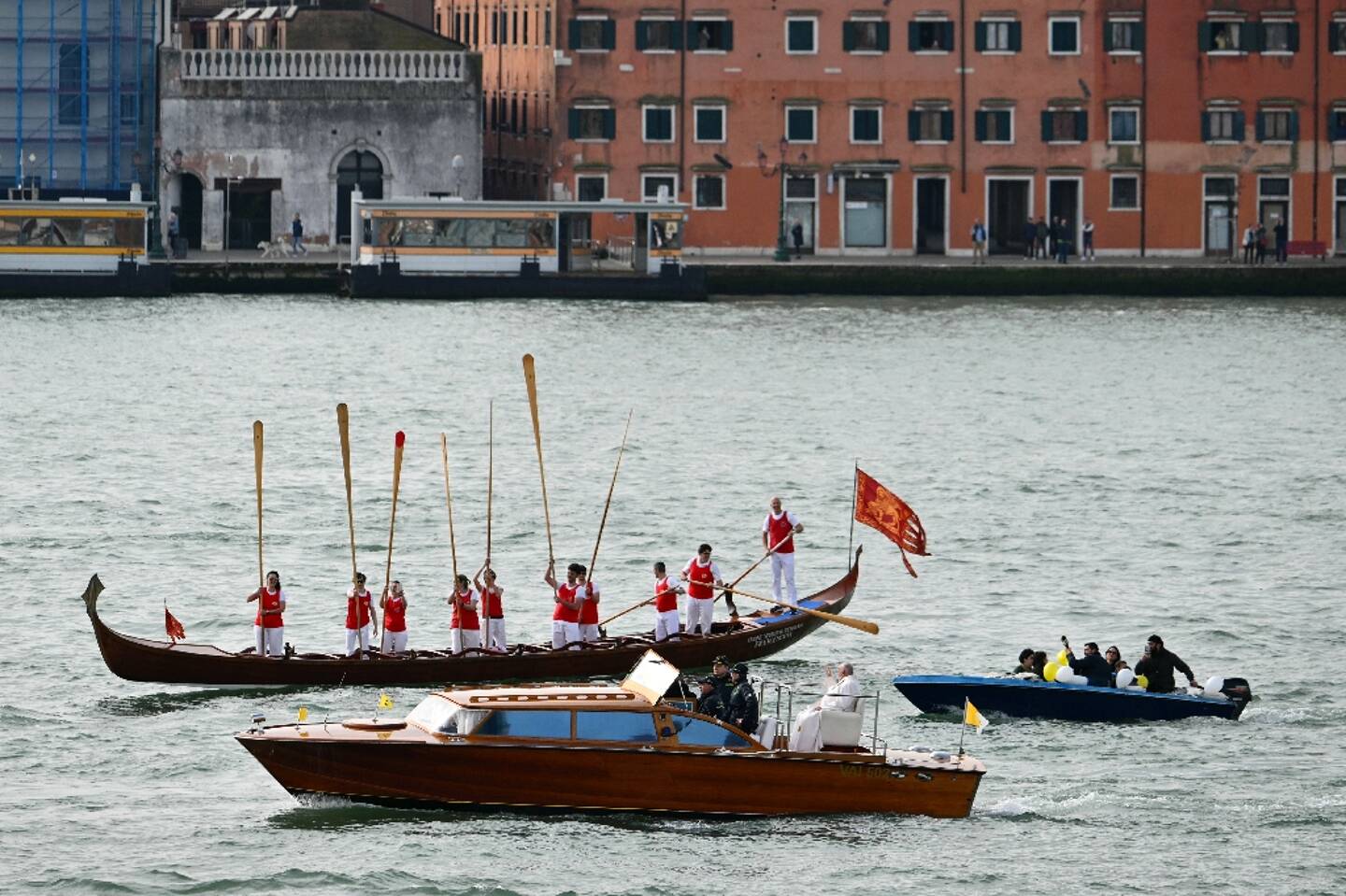 Le pape François salué par des gondoliers traverse la Lagune de Venise à bord d'une vedette, à Venise le 28 avril 2024
