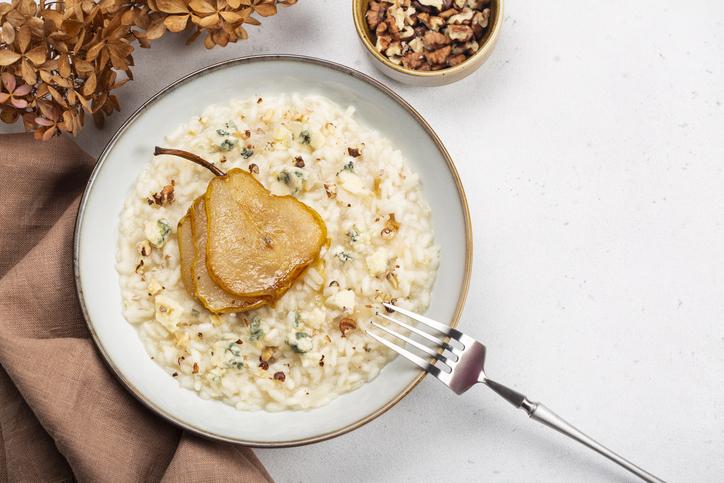 Risotto with gorgonzola cheese, pear and walnuts. Top view.